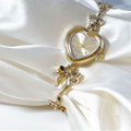Heart Case Bracelet Watch — Gold-Tone, Crystal Bezel, Champagne Dial & Bow Charm Chain, Women